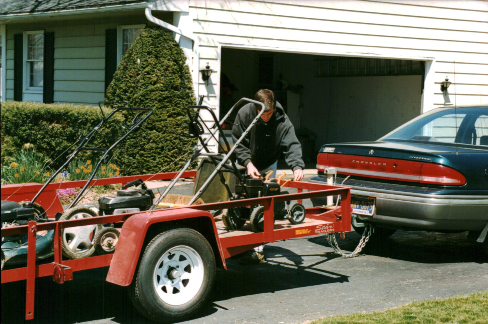 A man fixing the trailer of his car.